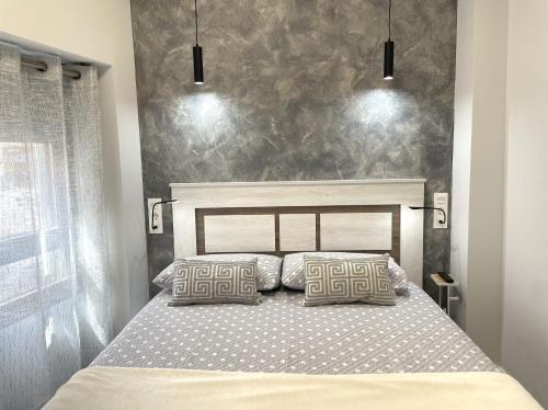 En eller flere senge i et værelse på Apartamentos Aranda - Roble