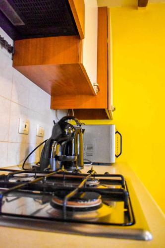 a kitchen stove top with a tea kettle on it at Ciceri Properties Ciancino in Verbania
