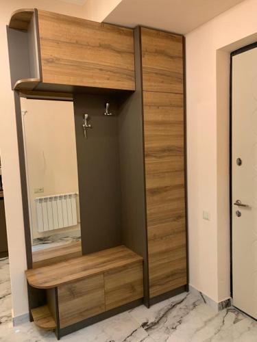 a room with a wooden closet with a mirror at Luxury Apartment with balcony in Yerevan