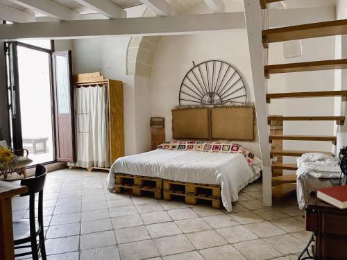 a bedroom with a bed and a large window at Novecento Room and Breakfast Puglia in Massafra