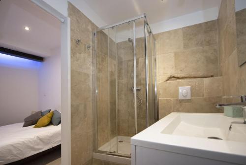 La salle de bains est pourvue d'une douche, d'un lavabo et d'un lit. dans l'établissement Sofi Ideal location equipage ou vacances Clim, à La Ciotat