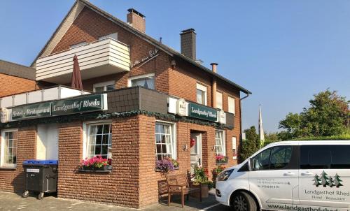 a white van parked in front of a brick building at Landgasthof Rheda Hotel - Restaurant in Rheda-Wiedenbrück