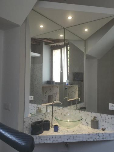 a bathroom with a sink and a large mirror at Casa Erika in Bracciano