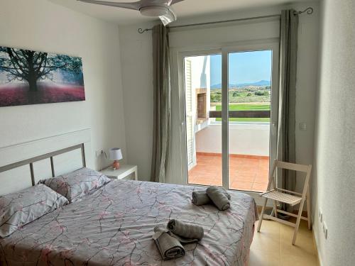 a bedroom with a bed and a sliding glass door at New Penthouse with a fantastic view in Murcia