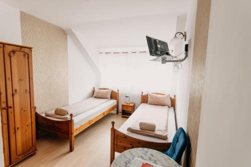 A bed or beds in a room at Palma Vendégház