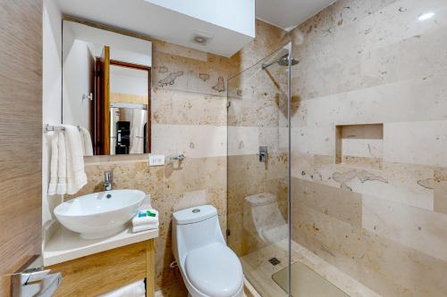 a bathroom with a toilet and a sink and a shower at Perfect Place 311 in Playa del Carmen