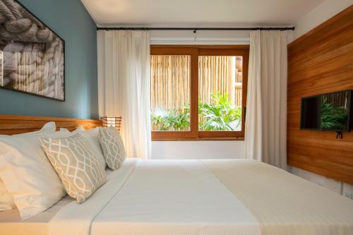 Ένα ή περισσότερα κρεβάτια σε δωμάτιο στο Santa Aldeia Hotel
