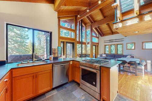 a kitchen with wooden cabinets and a stove top oven at Epic Mountain Escape in Tahoe Vista