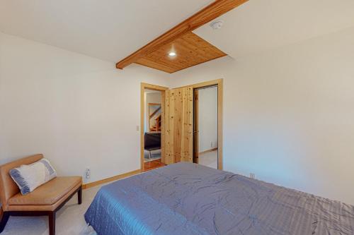 a bedroom with a bed and a chair in it at Epic Mountain Escape in Tahoe Vista