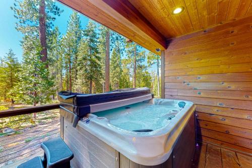 a jacuzzi tub in a wooden room with trees at Epic Mountain Escape in Tahoe Vista
