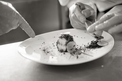 a person eating a piece of cake on a plate at SPA Hotel Splendor in Lubenia