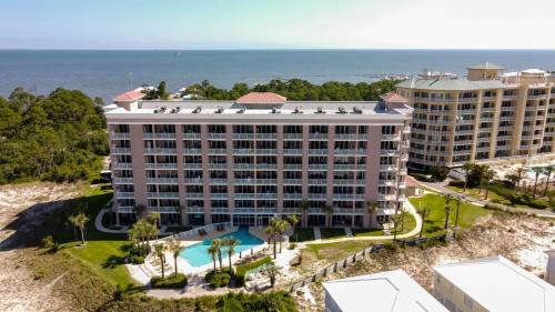 an aerial view of a hotel with the ocean in the background at The Dunes 507 by Vacation Homes Collection in Gulf Shores