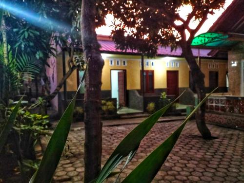 a house with a cobblestone street in front of it at Mango Homestay in Sekotong
