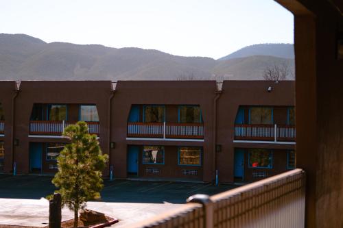 a building with a tree in front of it at Taos Valley Lodge in Taos