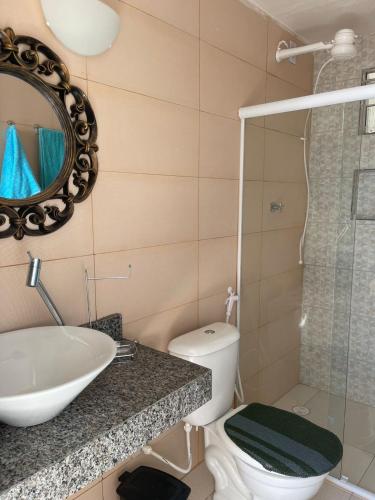 a bathroom with a sink and a toilet and a mirror at Apartamento Novo em Piranhas in Piranhas