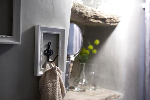 a bathroom sink with a mirror and a towel at Traditional Village House in Istérnia