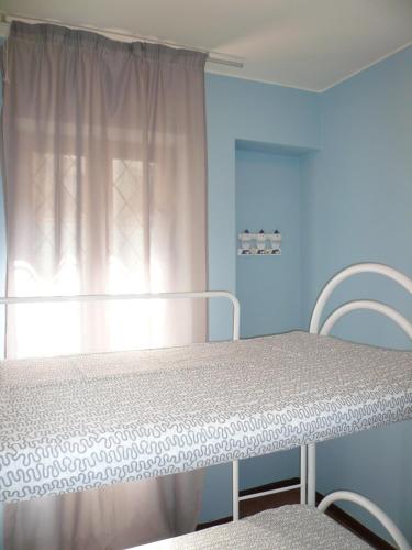 a hospital bed in a room with a window at Oasi Holiday Home in Toscolano Maderno