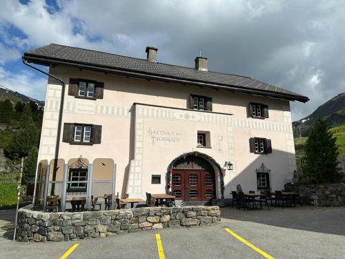 a large white building with a large doorway at Hotel Tschuggen Davos in Davos