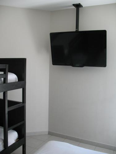 a flat screen tv hanging on a white wall at Fasthotel Montpellier Baillargues in Baillargues