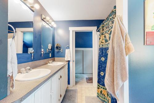 a blue bathroom with a sink and a shower at Sheridans Getaway in Newry
