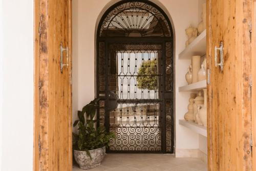 an entrance door to a home with a wrought iron gate at Casa Aura Hotel in Vejer de la Frontera