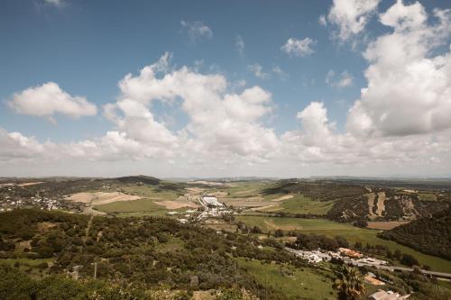 a view of a valley with trees and a city at Casa Aura Hotel in Vejer de la Frontera