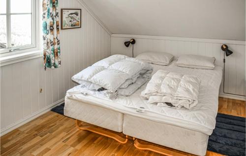 a white bed with white sheets and pillows on it at Beautiful Apartment In Rauland With Sauna in Rauland