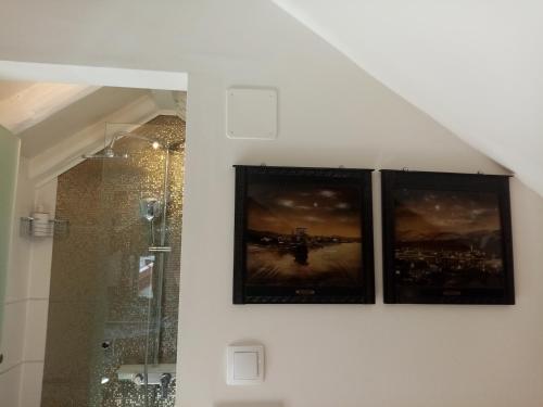 three pictures hanging on a wall in a bathroom at Apartments & Rooms Trogir Stars FREE PARKING in Trogir