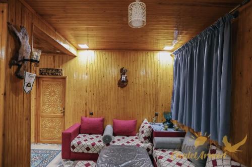 a bedroom with a bed and a couch in a room at Atlas Chalet Armed in Imlil