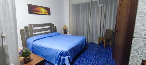 a bedroom with a bed and a table and a chair at Casa OASI in Formia
