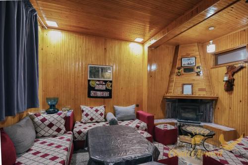 a living room with a couch and a fireplace at Atlas Chalet Armed in Imlil