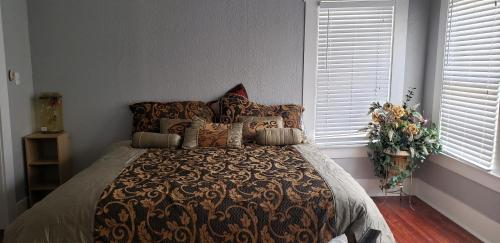 a bedroom with a bed with a blanket and pillows at Home away from home in San Antonio