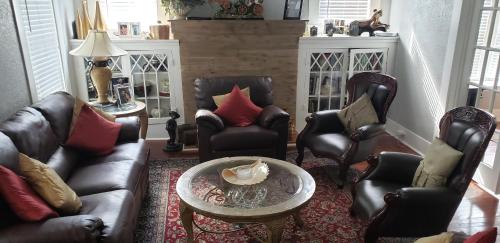 a living room with leather chairs and a table at Home away from home in San Antonio