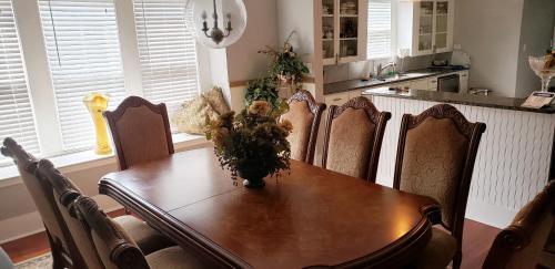 a dining room table with chairs and a kitchen at Home away from home in San Antonio