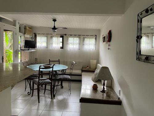 a kitchen and living room with a table and chairs at Pousada Saint Germain in Búzios
