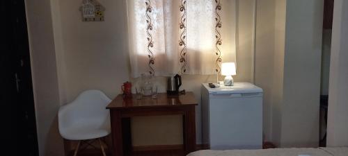 a small room with a table and a washing machine at Guest House LIBU Zugdidi in Zugdidi