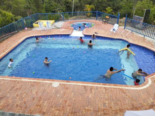 a group of people in a swimming pool at CASA MAS GARAJE con Piscina fuera del alojamiento a 2 K m s in San Gil