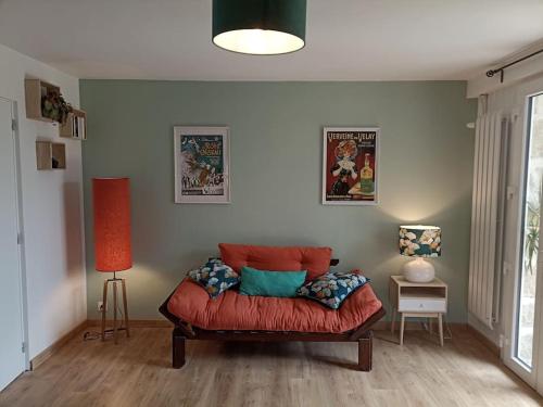 a living room with a red couch in a room at Studio chemin de Saint Jacques in Vals-près-le-Puy