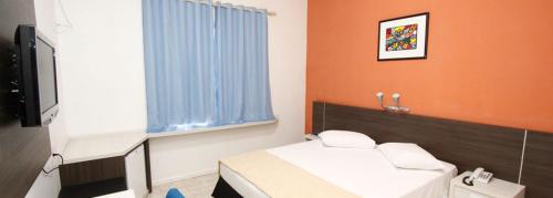 HOTEL ITACAIUNAS tesisinde bir odada yatak veya yataklar