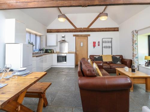 a living room with a couch and a table at The Long Barn in Attlebridge