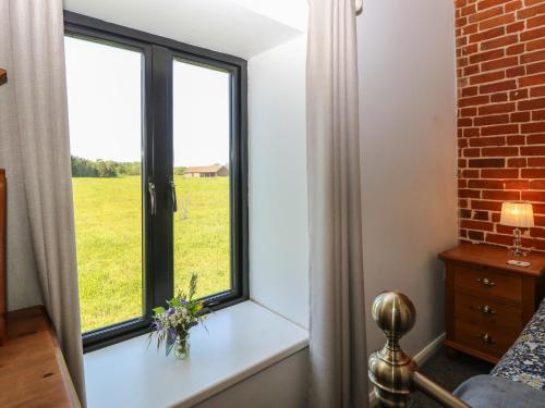 a room with a window with a view of a field at The Long Barn in Attlebridge