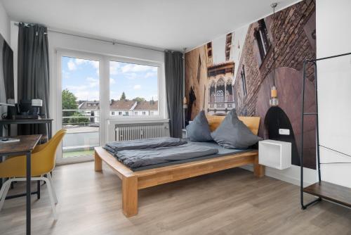 a bedroom with a bed and a large window at Apartment 5, direkt am Bahnhof in Aachen