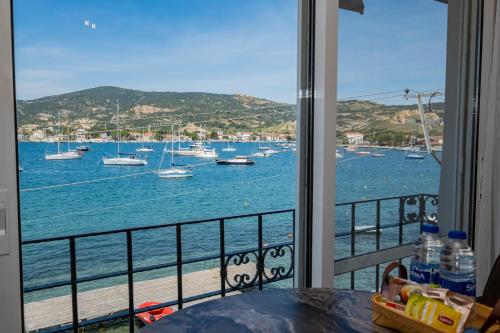 a view of the water from a balcony with boats at BD SUITES in Foça