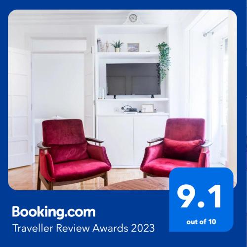 two red chairs in a living room with a tv at Your Place in Lisbon in Lisbon