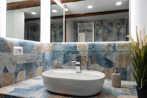 a bathroom with a white sink on a counter at Two Rooms Chiaia 37 in Naples