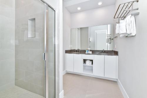 ein Bad mit einer Dusche und einem Waschbecken in der Unterkunft Relaxing Condo With Resort Amenities near Disney - B49 #115 in Kissimmee