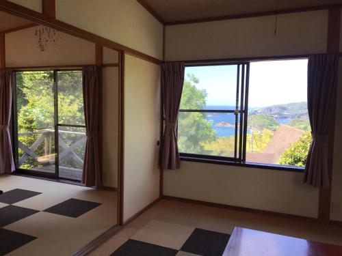 a room with two windows and a view of a mountain at Marine View Shimane - Vacation STAY 85912v in Matsue