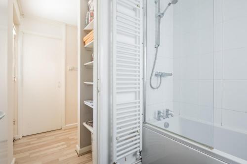 a bathroom with a shower and a white closet at Comfy Central Apartment in Cambridge in Cambridge