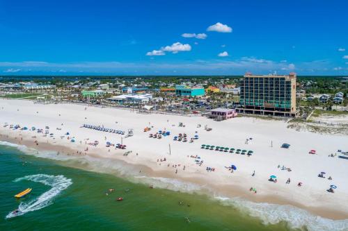 an aerial view of a beach with people on it at Phoenix All Suites Hotel in Gulf Shores