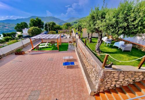 a house with a patio and a view of the water at Acquamarina in Gaeta